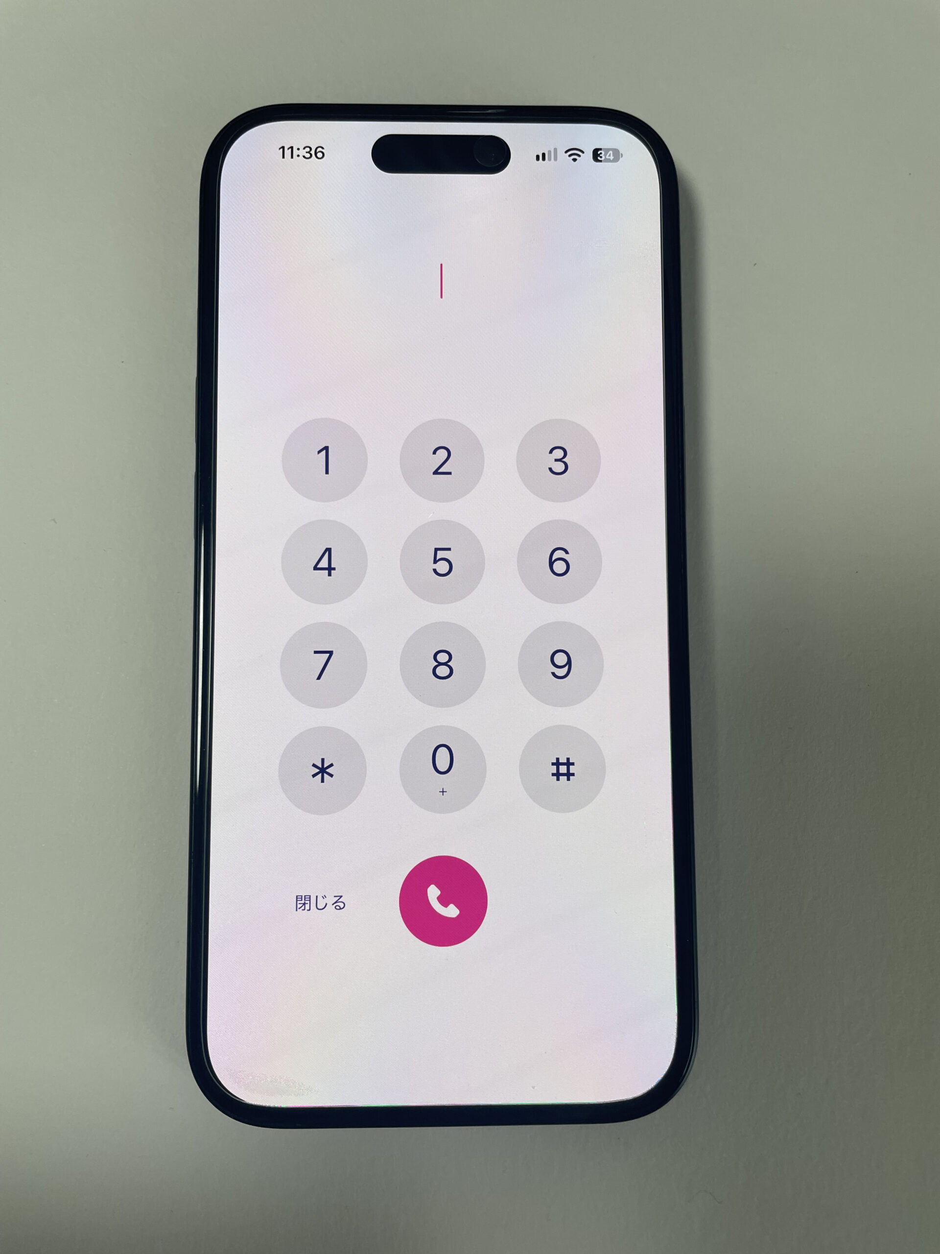iPhoneで開いたRakuten Linkの電話番号入力画面とピンク色の発信ボタン